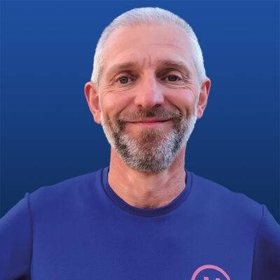 Headshot of Dr Simon Tobin from the shoulders up smiling.