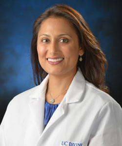 uci health pain management specialist and orange county medical association president dr shalini shah in a blue studio background wearing a white coat