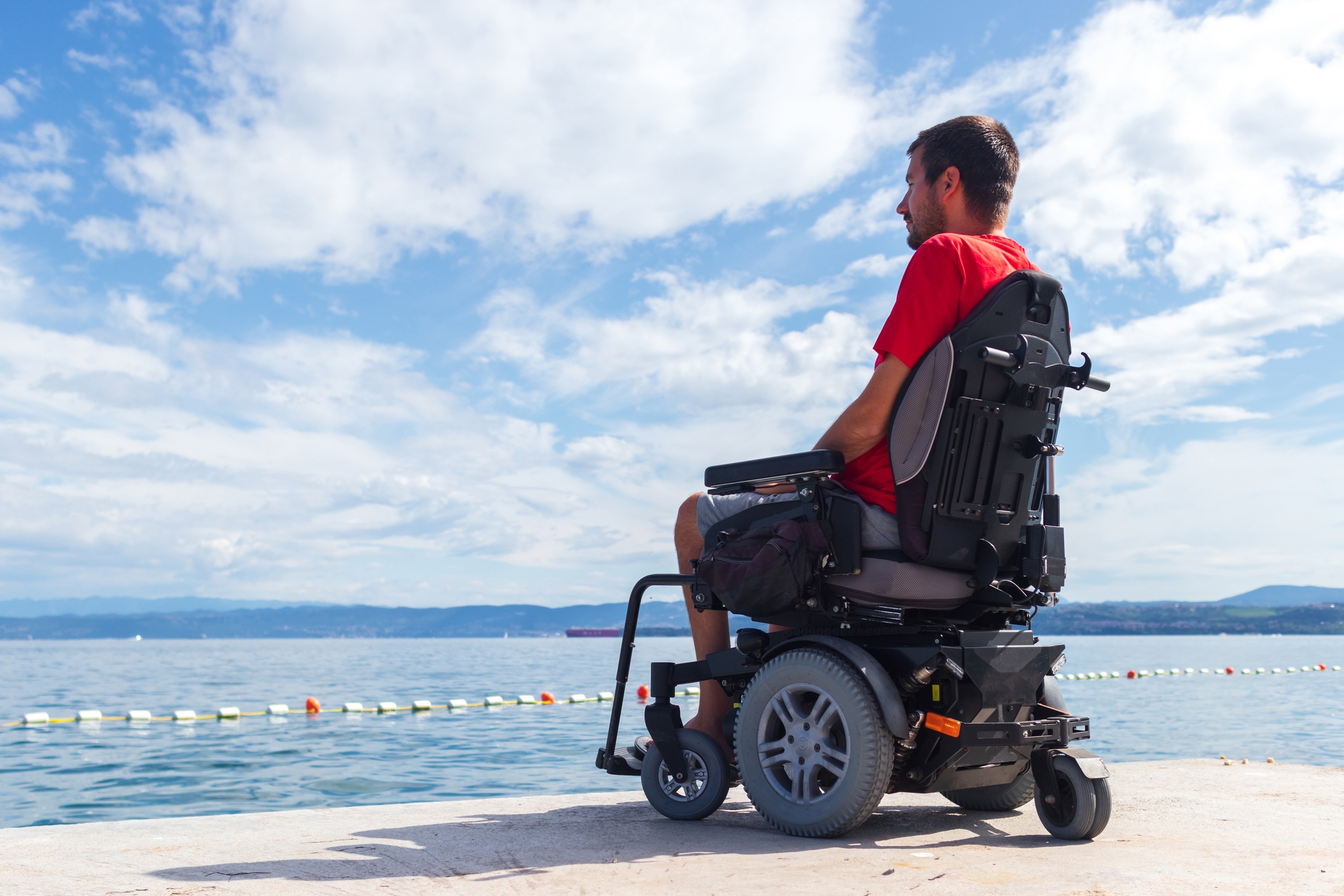 Man on wheelchair on a beach