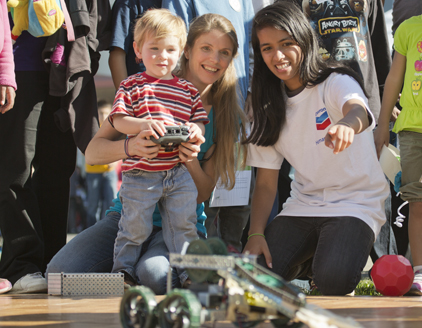 Student teaching mother and child about robotics at the CSU (California State University) East Bay Science Festival 2013 in Hayward, California.