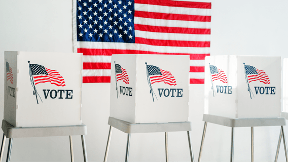 Voting booths in front of an American flag