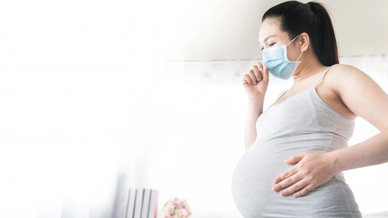 Image of a pregnant person wearing a face mask