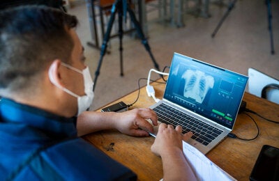 Health worker uses imaging to identify the presence of TB in patient.