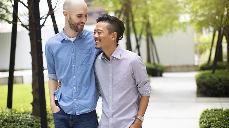 two men walk together outside