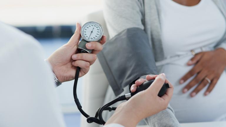 Shot of an unrecognizable female doctor checking the blood pressure of a pregnant patient at a hospital during the day