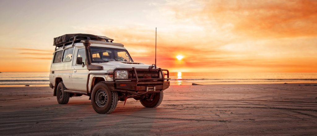 Car on Beach at sunset