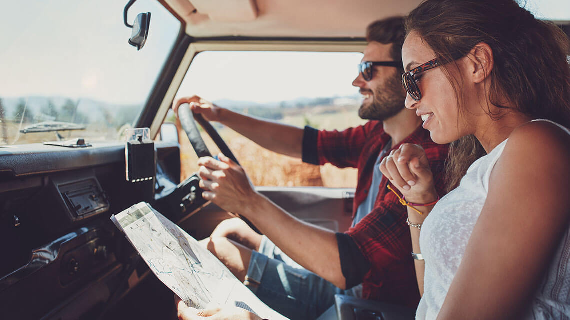 A family in a car on a road trip