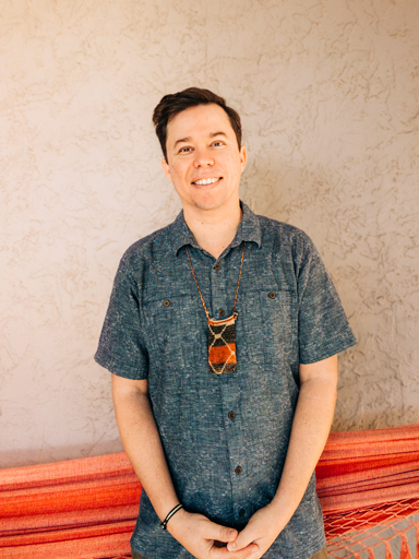 Photo portrait of Frank, smiling, looking at the reader.