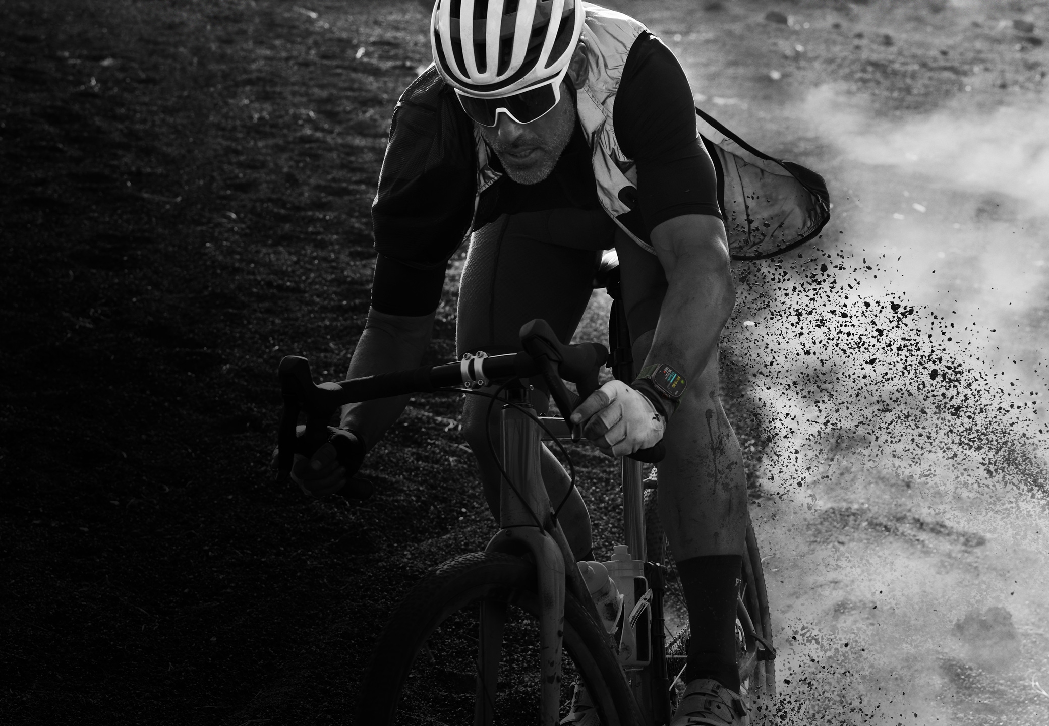 A person riding a bicycle down a rocky trail wearing Apple Watch Ultra 2.