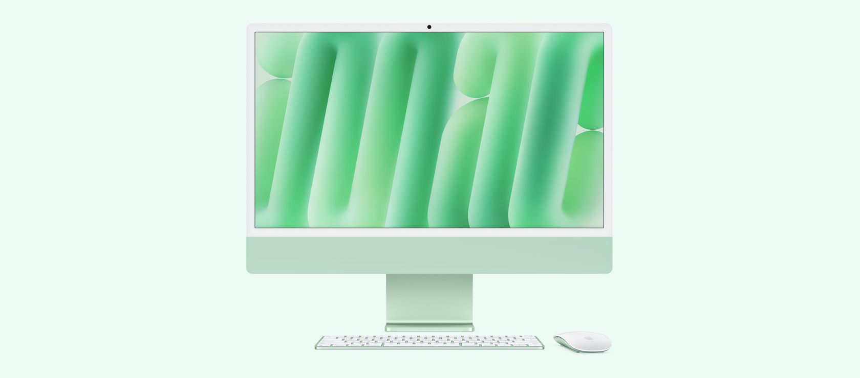 绿色 iMac 配同色系鼠标和键盘的正面视图