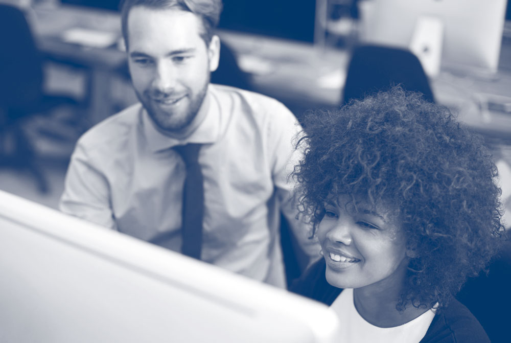 Two people sat at a computer