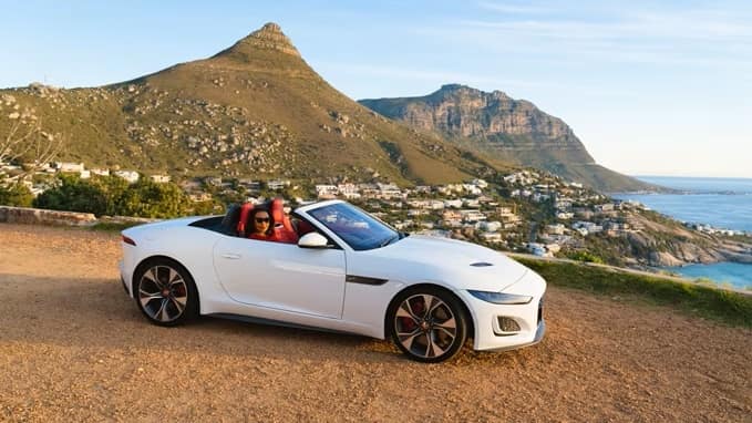 White Jaguar driving with scenery