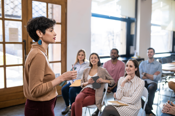 An engaged educator speaks in front of a...