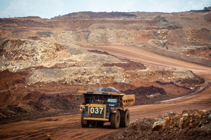 Rear view of a heavy truck driving through a nickel mine