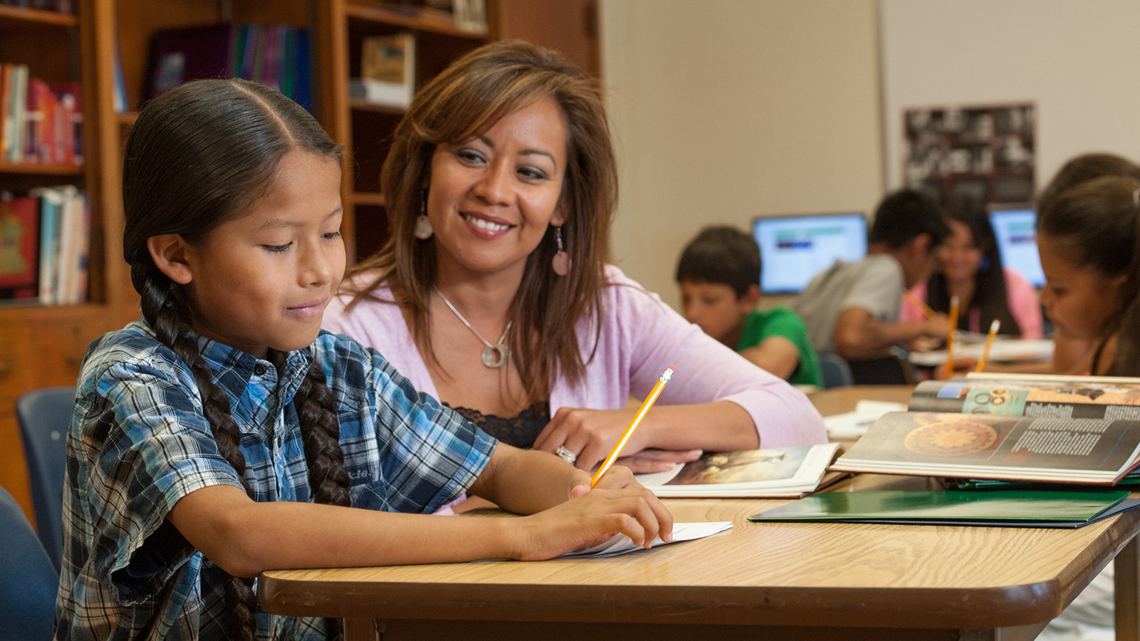 Student with teacher in a classroom setting.