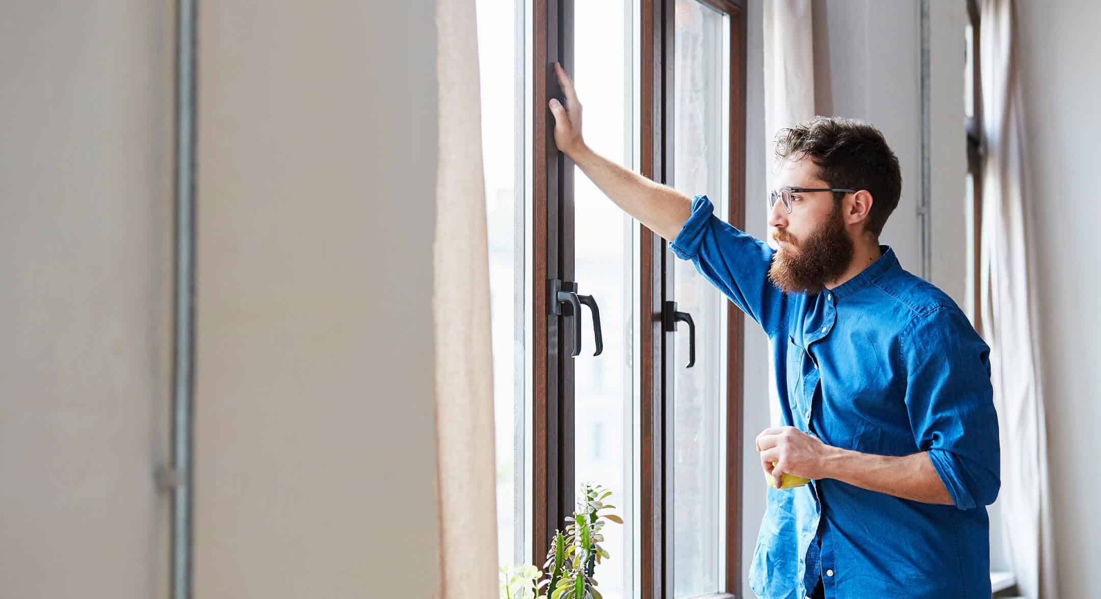 Man looking out of a window in contemplation