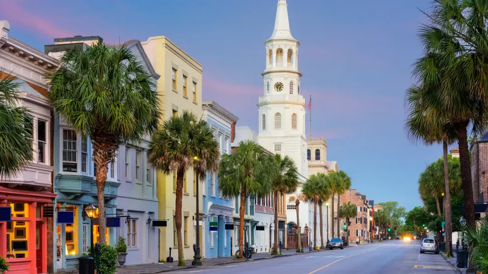 Houses with bright colors and palms along a Charleston, South Carolina, street