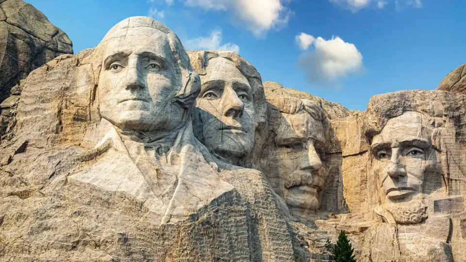 Close of view of Mount Rushmore with carved busts of four American presidents