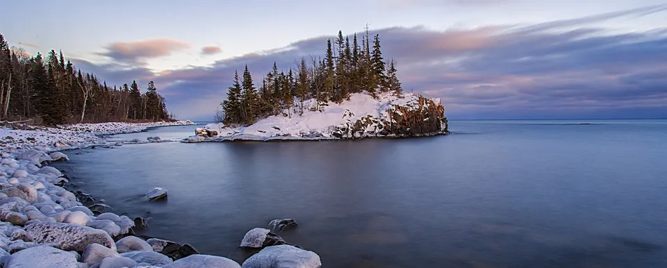 Snowy evergreens on a small island just off of a Minnesota lake shoreline