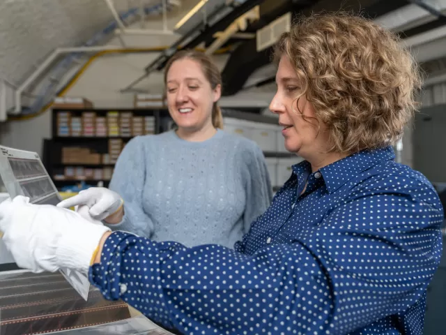 Two people looking at film.