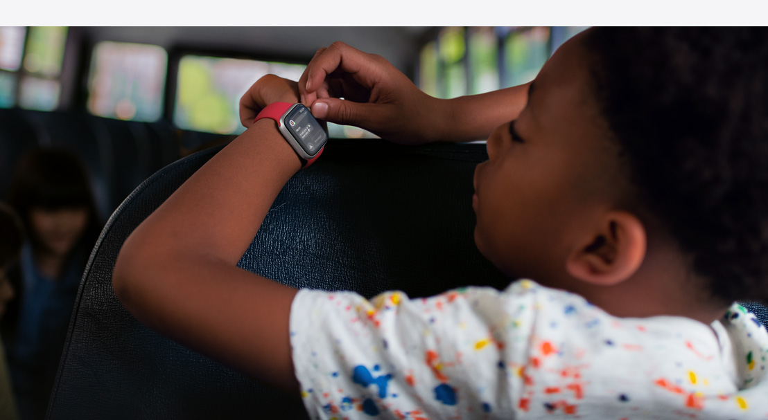 Illustration of two childrens’ hands and an adult hand holding an iPhone 16. Each child is wearing an Apple Watch SE. The adult hand is setting up Apple Watch For Your Kids.