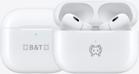 Two AirPods 4 charging cases engraved with example emojis: one with a cat emoji on either side of the text B&T and another with a crab emoji