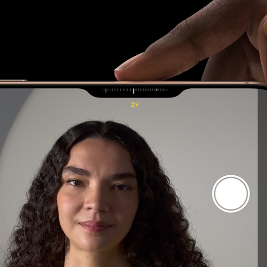 A finger slides along the Camera Control button to adjust the zoom