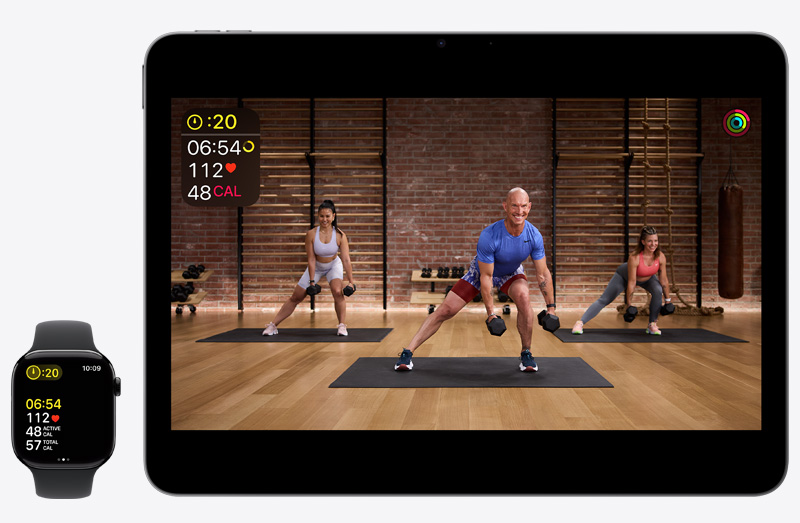 An iPad 13-inch Pro showing an Apple Fitness+ workout next to an Apple Watch Series 10 tracking that same Apple Fitness+ workout.