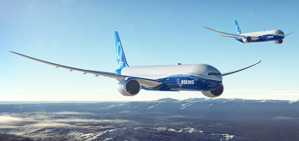 777X in flight over mountains