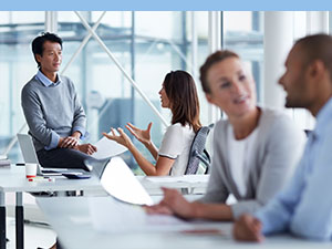 multiple groups of people sitting at desks having discussions