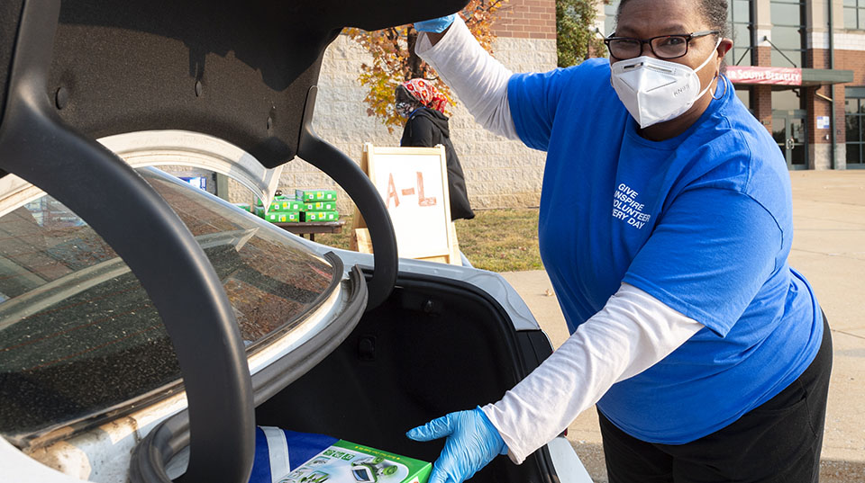 Volunteers places FUTURE U STEM kit in car