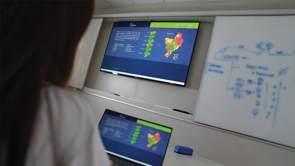 Person views fuel data and maps on large monitor