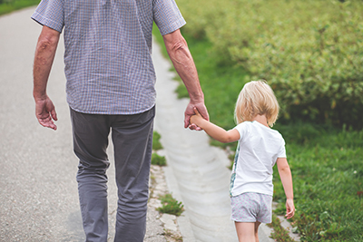 photo of a man holding a young girl's hand