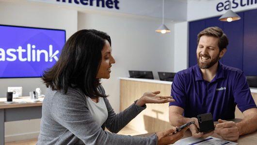 An Eastlink retail representative and customer in an Eastlink store.