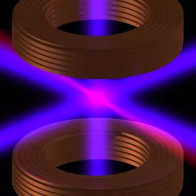 Laser light in pink and purple crosses between two cylindrical shapes on a black background. 