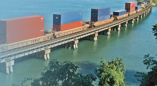 TTX railcars on elevated track over water