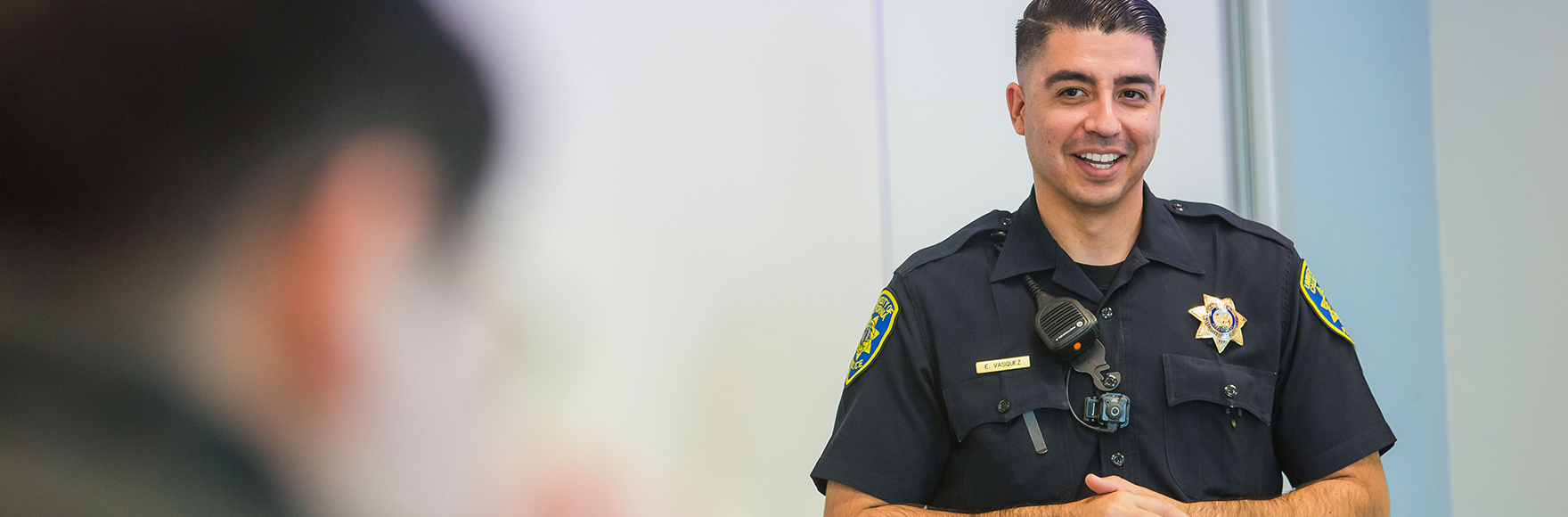 Officer showing a community member the patrol car