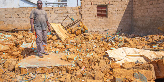 Moussa Keita amid the ruins of his home.