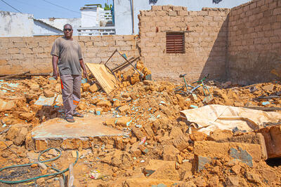 Moussa Keita amid the ruins of his home.