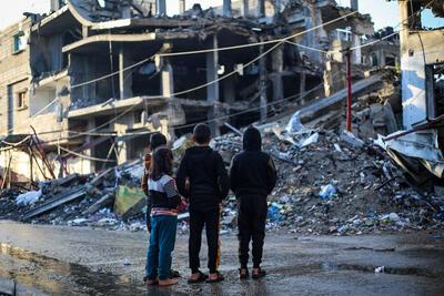 Children stand in front of a house demolished by a bombardment in the city of Rafah, south of the Gaza Strip