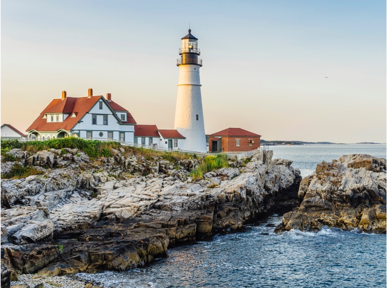 Lighthouse overlooking the ocean at sunset