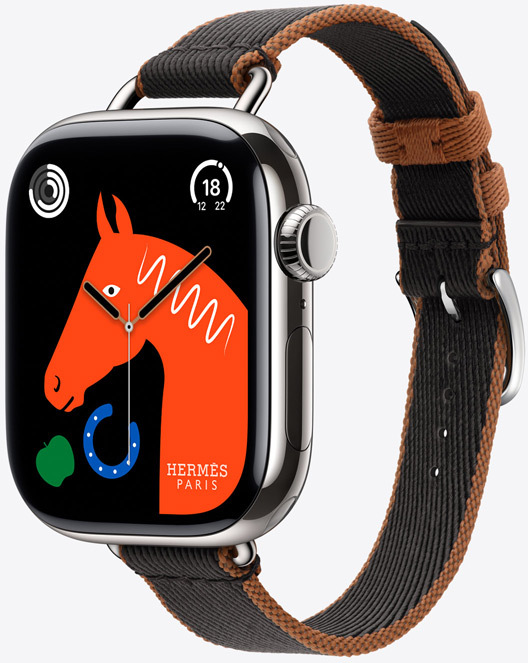 Vue oblique du nouveau bracelet Simple Tour Twill Jump Attelage en Noir/Gold avec le cadran Lucky Horse présentant une tête de cheval orange, une pomme verte et un fer à cheval bleu.