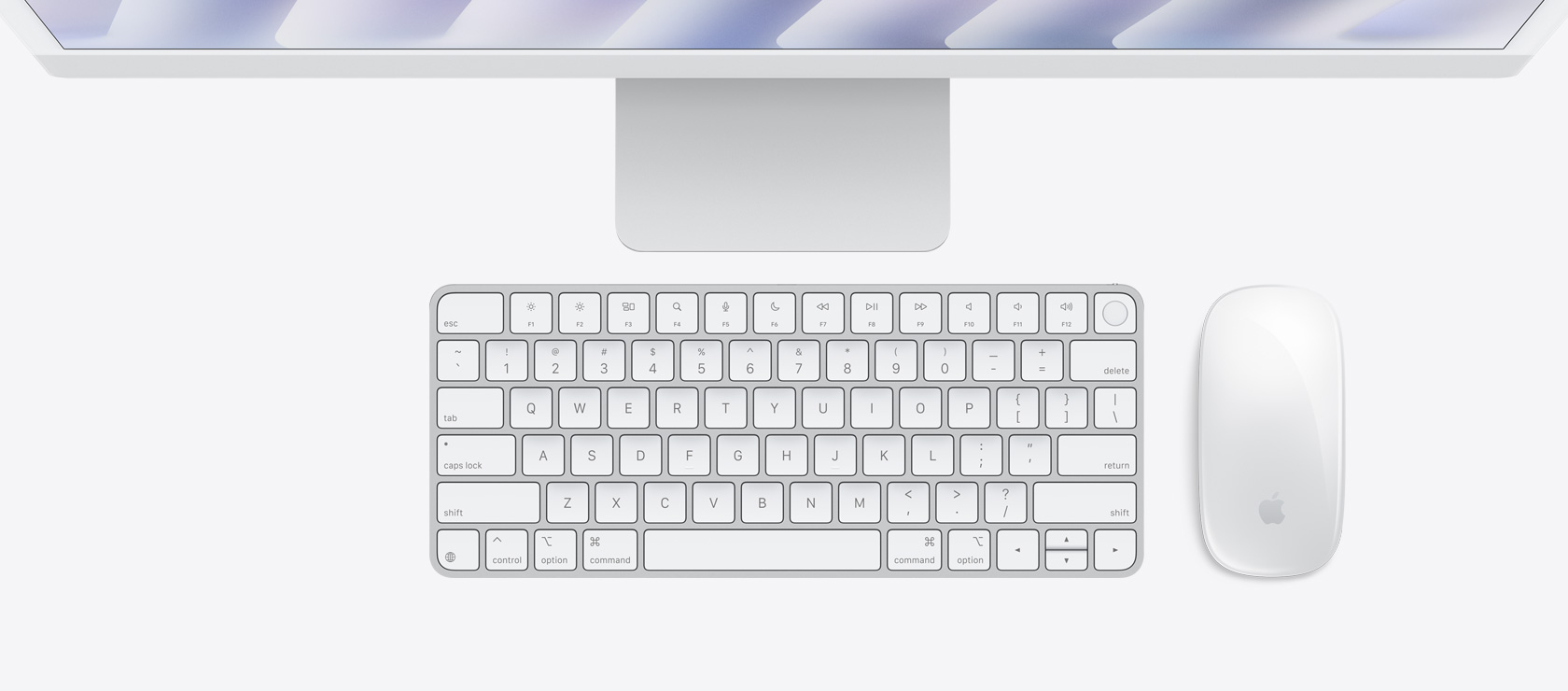 Overhead view of silver iMac with color-matching mouse and keyboard