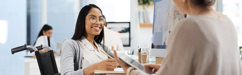 two people in the workplace working together