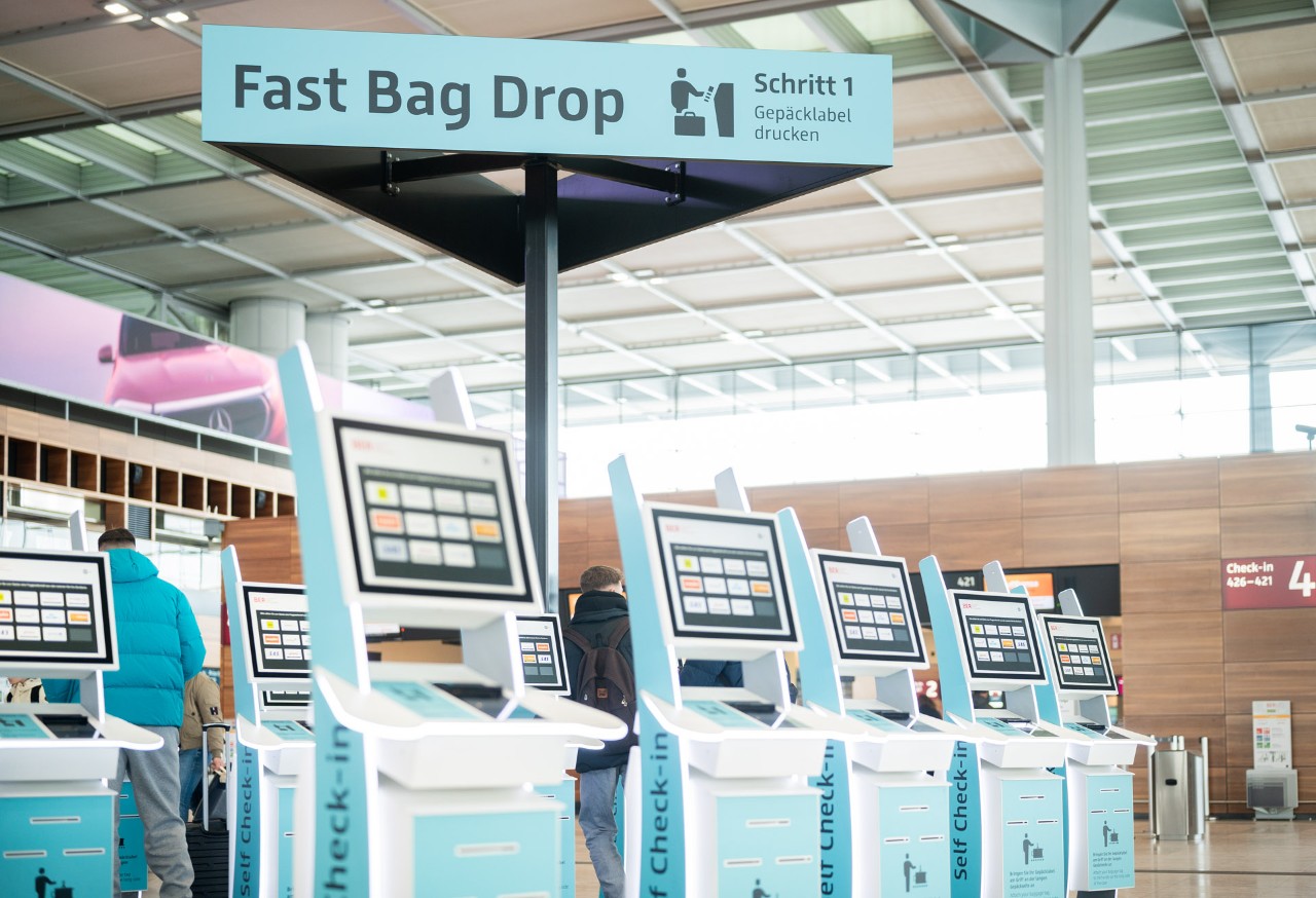 Self Service Machine. Check-in facilities in the background