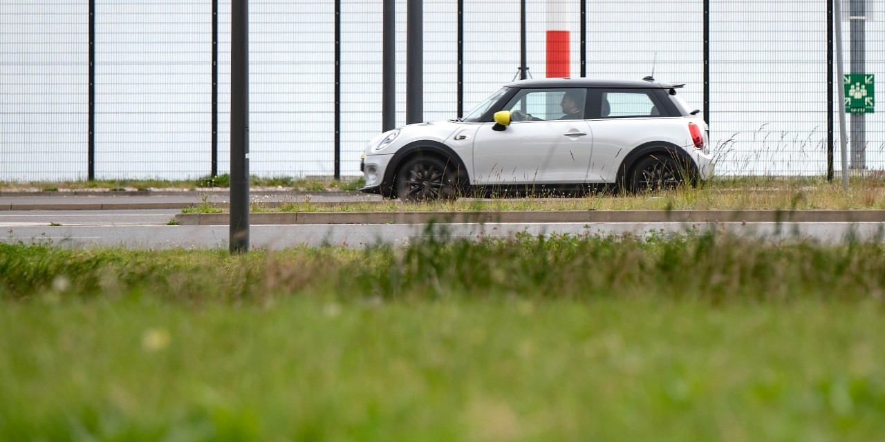 A vehicle drives along the airport grounds.