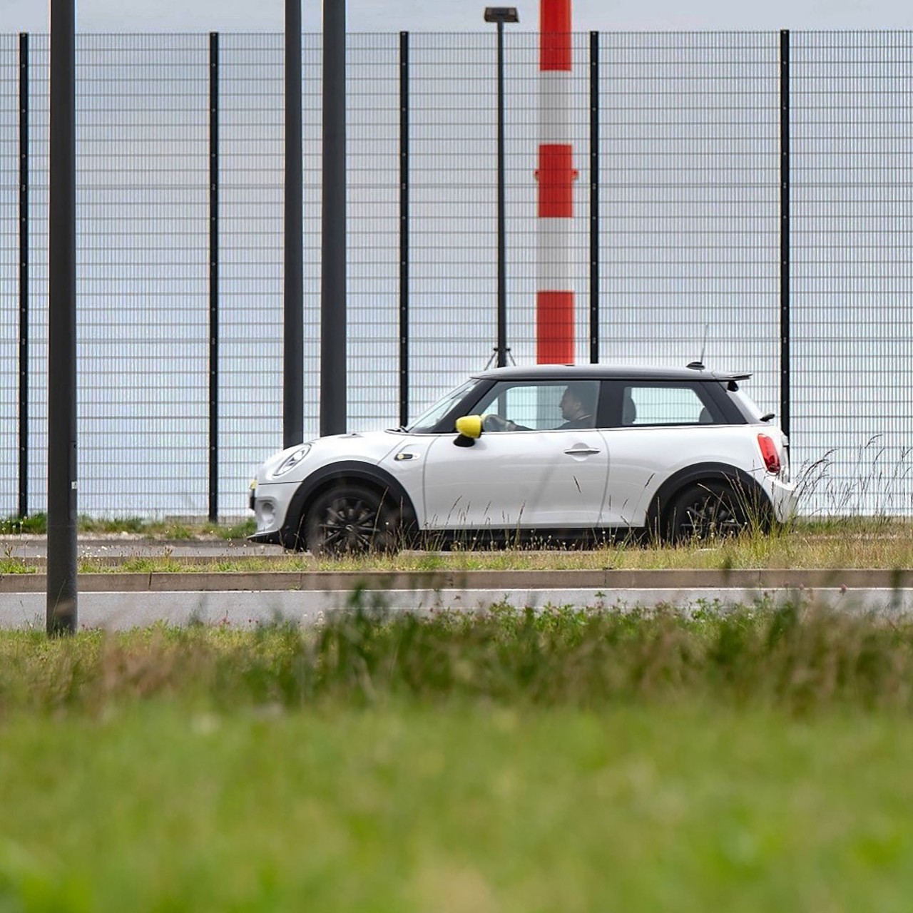 A vehicle drives along the airport grounds.