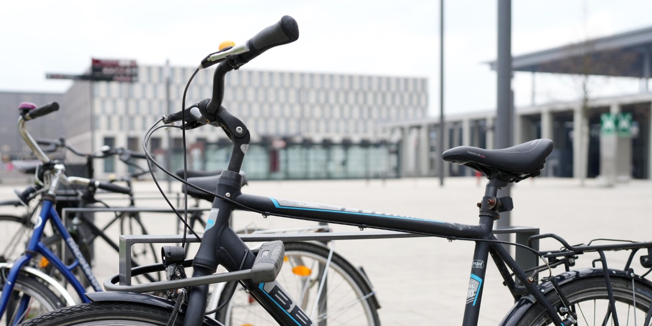 Bicycle at the bicycle stand. Behind it the Willy-Brandt-Platz