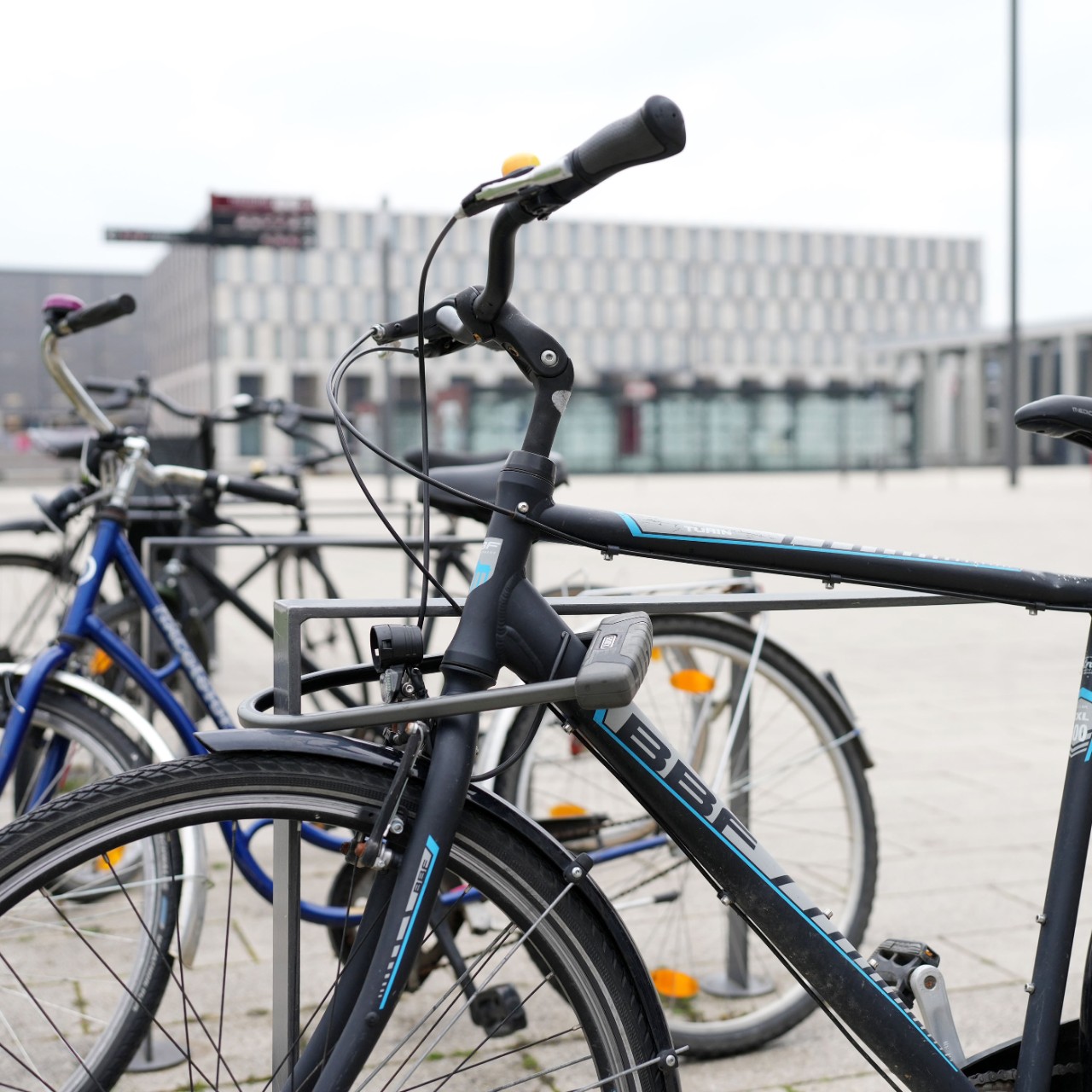 Bicycle at the bicycle stand. Behind it the Willy-Brandt-Platz