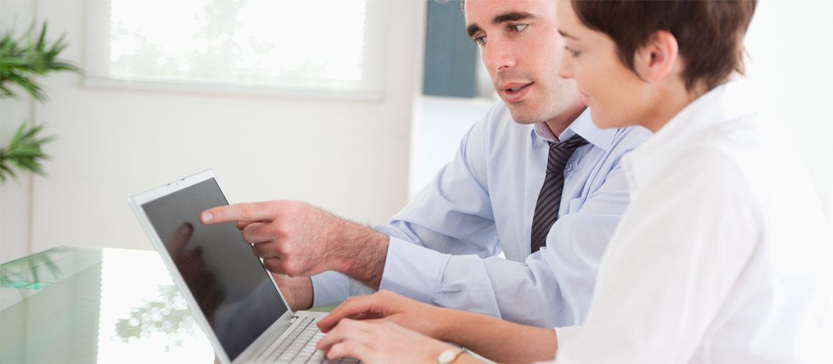 woman and man looking at a laptop